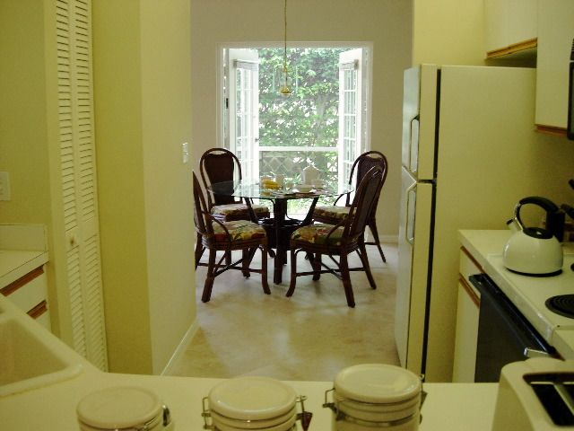 View from kitchen to breakfast area and French doors